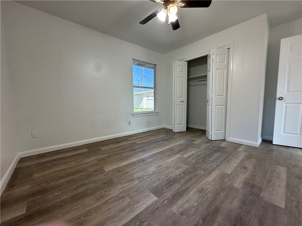 317 Redwood Drive Mathis, TX 78368 - Photo 16 of 26 an empty room with chandelier fan and windows