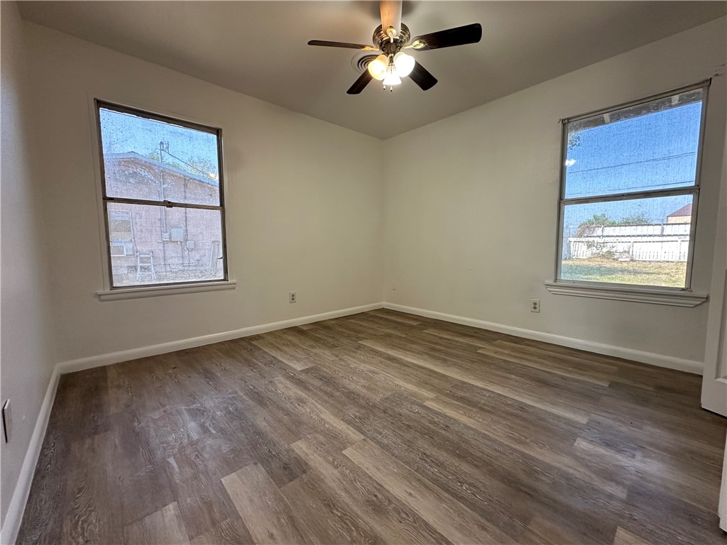 317 Redwood Drive Mathis, TX 78368 - Photo 17 of 26 a view of empty room with wooden floor and fan