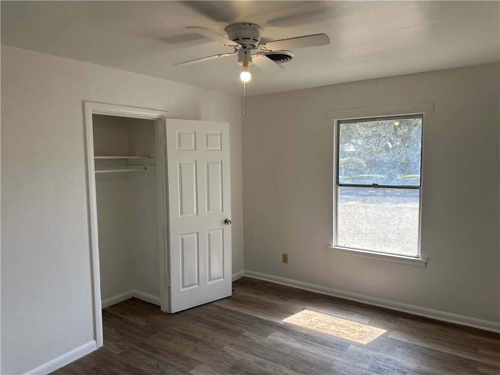317 Redwood Drive Mathis, TX 78368 - Photo 19 of 26 a view of an empty room with wooden floor and a window