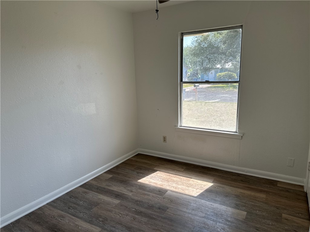 317 Redwood Drive Mathis, TX 78368 - Photo 26 of 26 an empty room with wooden floor and windows