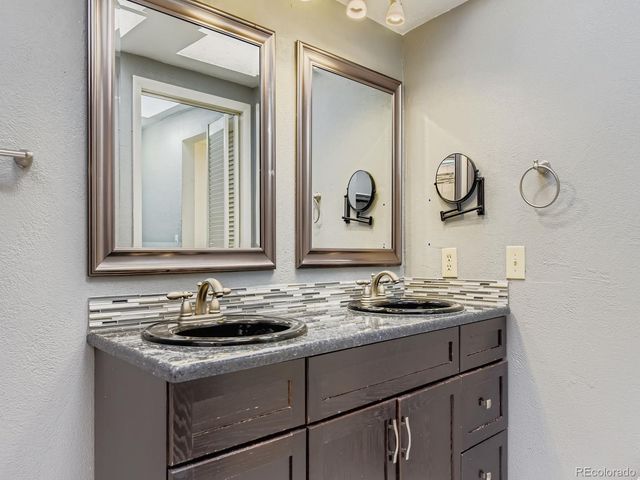 a bathroom with a shower and a sink