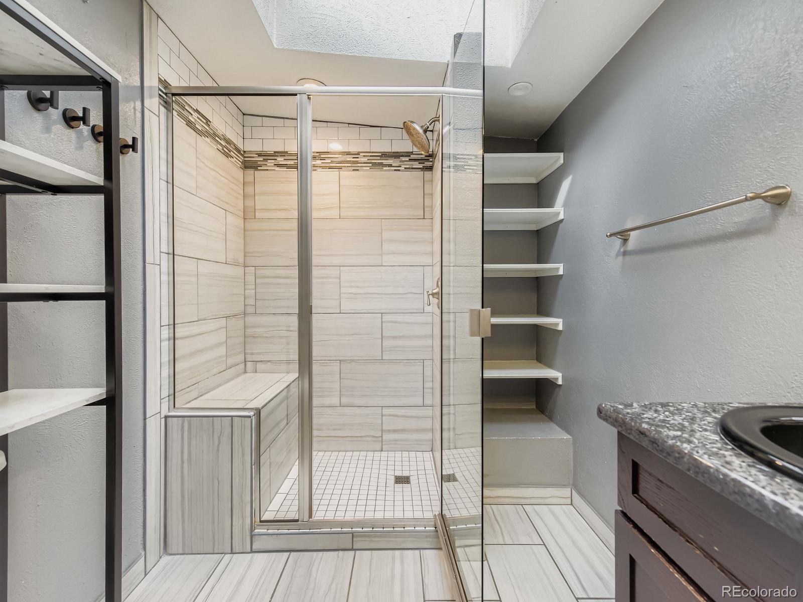 6536 South Kit Carson Street Centennial, CO 80121 - Photo 12 of 32 a bathroom with a shower and a sink