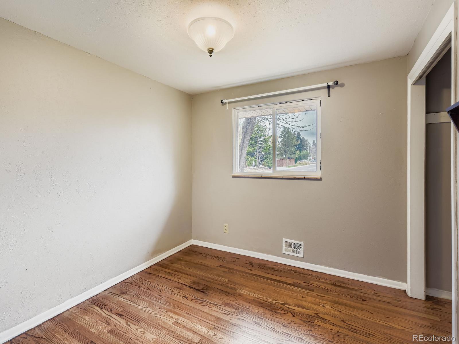 6536 South Kit Carson Street Centennial, CO 80121 - Photo 17 of 32 an empty room with wooden floor and windows