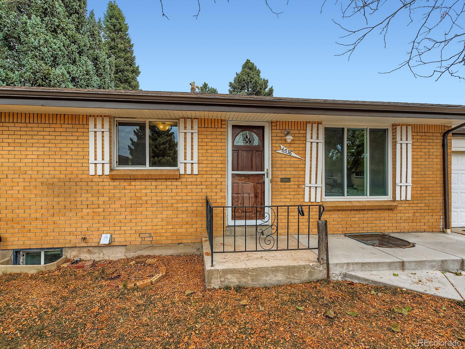 6536 South Kit Carson Street Centennial, CO 80121 - Photo 2 of 32 a front view of a house with a yard