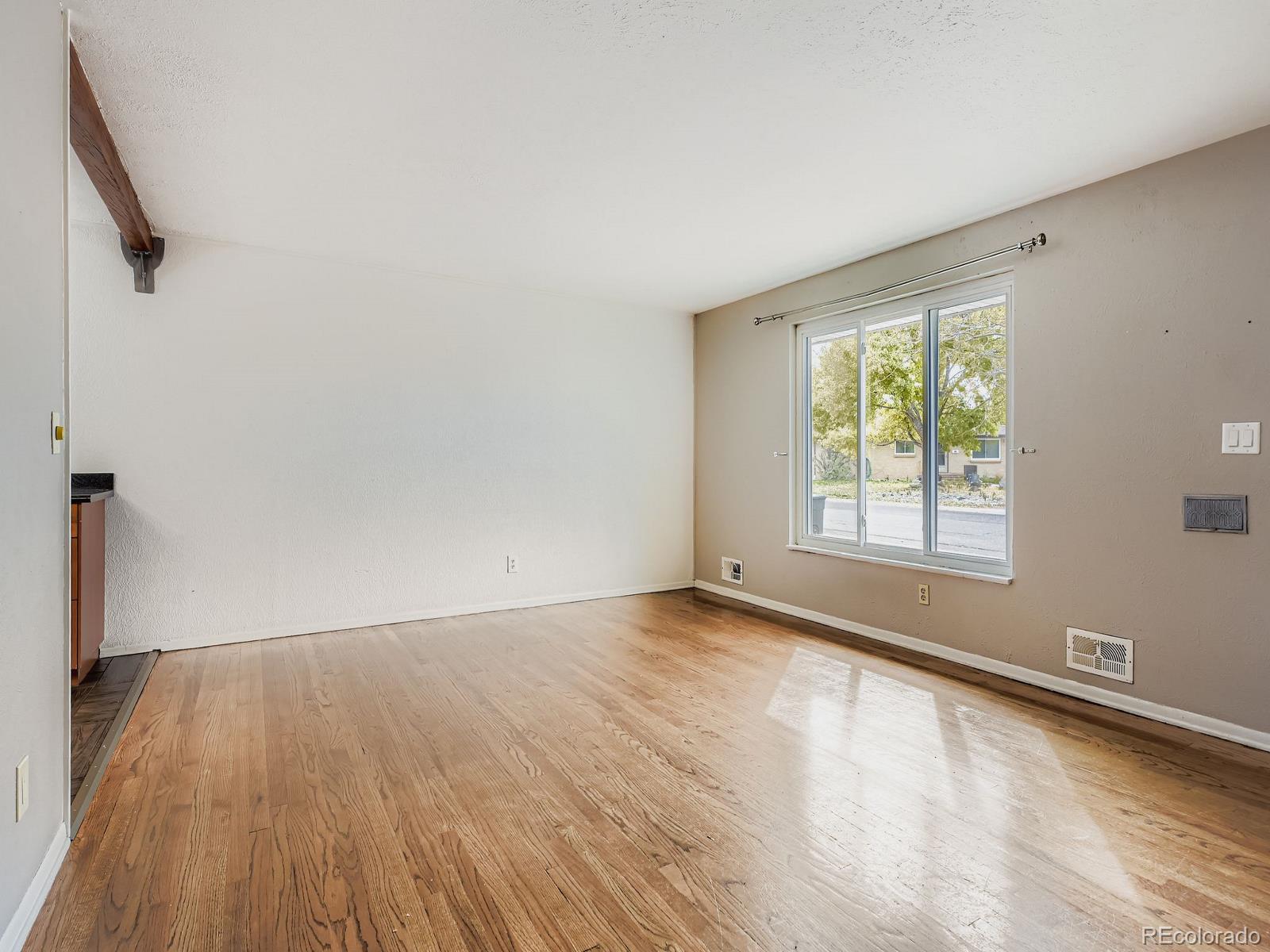 6536 South Kit Carson Street Centennial, CO 80121 - Photo 5 of 32 an empty room with wooden floor and windows