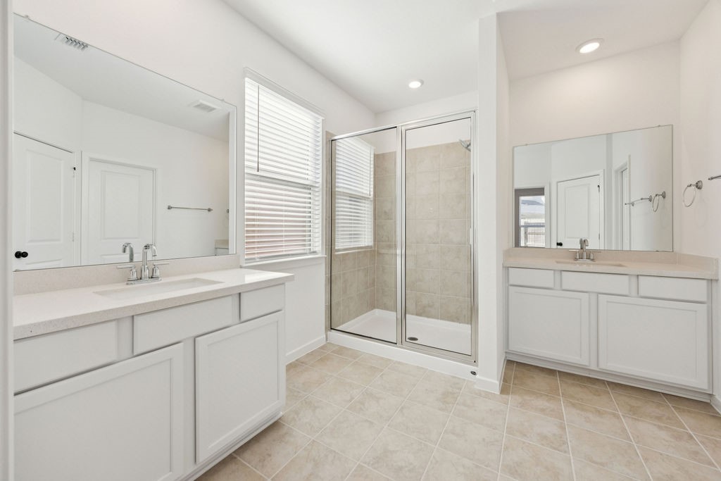 8922 Riverton Rdg Road Cypress, TX 77433 - Photo 13 of 25 a bathroom with a shower sink and mirror