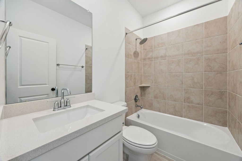 8922 Riverton Rdg Road Cypress, TX 77433 - Photo 16 of 25 a bathroom with a sink a toilet and bathtub