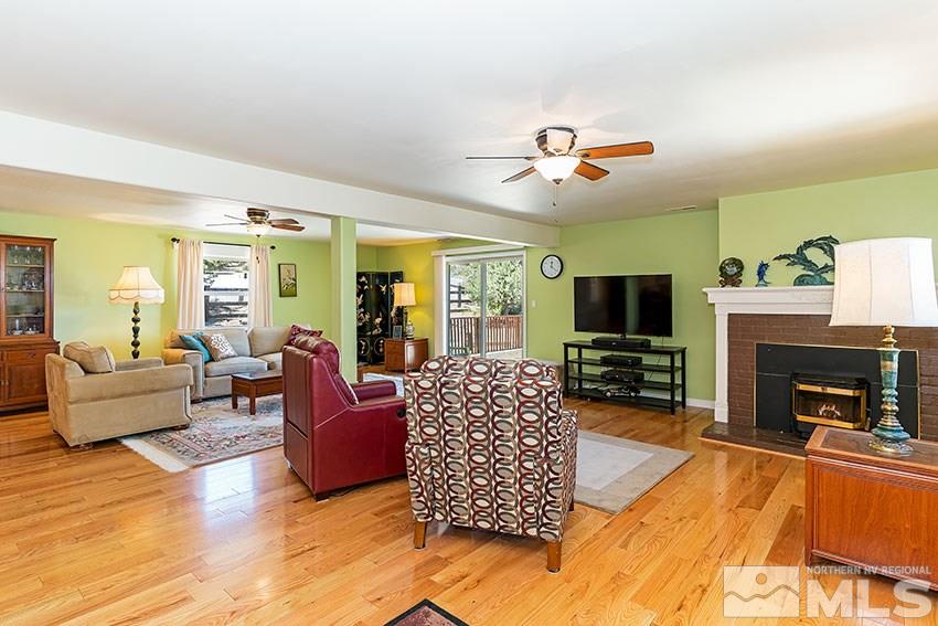 2141 Cartwright Road Reno, NV 89521 - Photo 3 of 23 a living room with furniture a flat screen tv and a fireplace