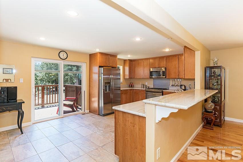 2141 Cartwright Road Reno, NV 89521 - Photo 7 of 23 a large kitchen with a large window and stainless steel appliances