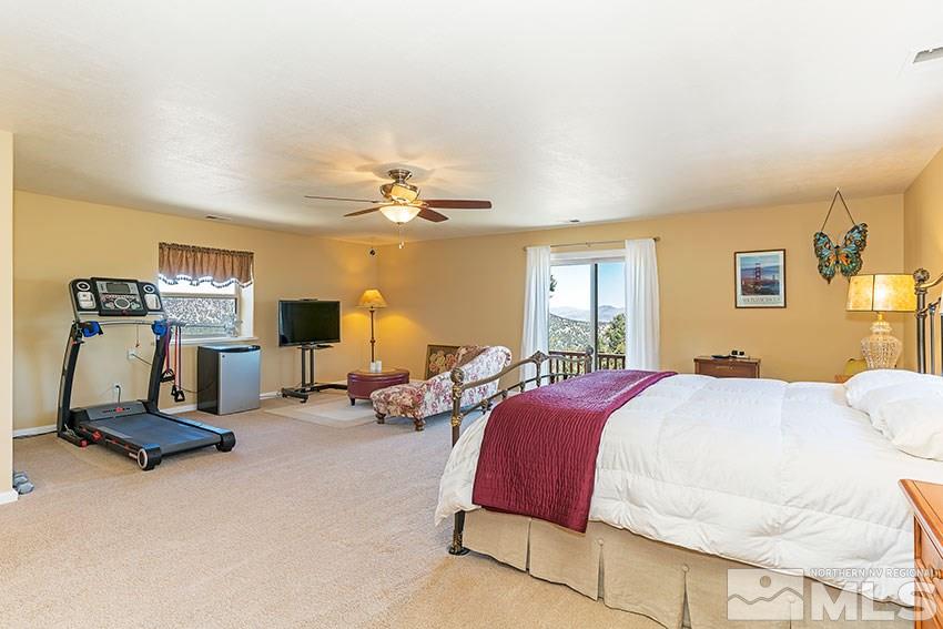 2141 Cartwright Road Reno, NV 89521 - Photo 10 of 23 a spacious bedroom with two bed and a chandelier