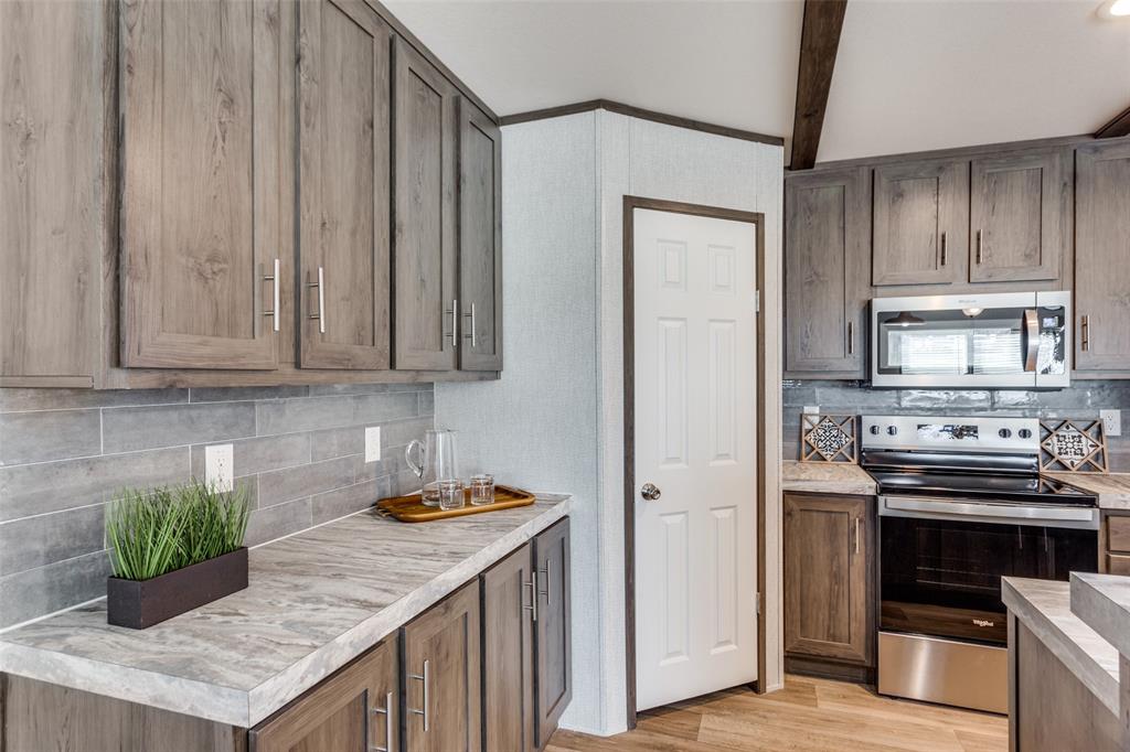 175 Cedar Drive Azle, TX 76020 - Photo 11 of 25 a kitchen with stainless steel appliances granite countertop a refrigerator and a stove top oven