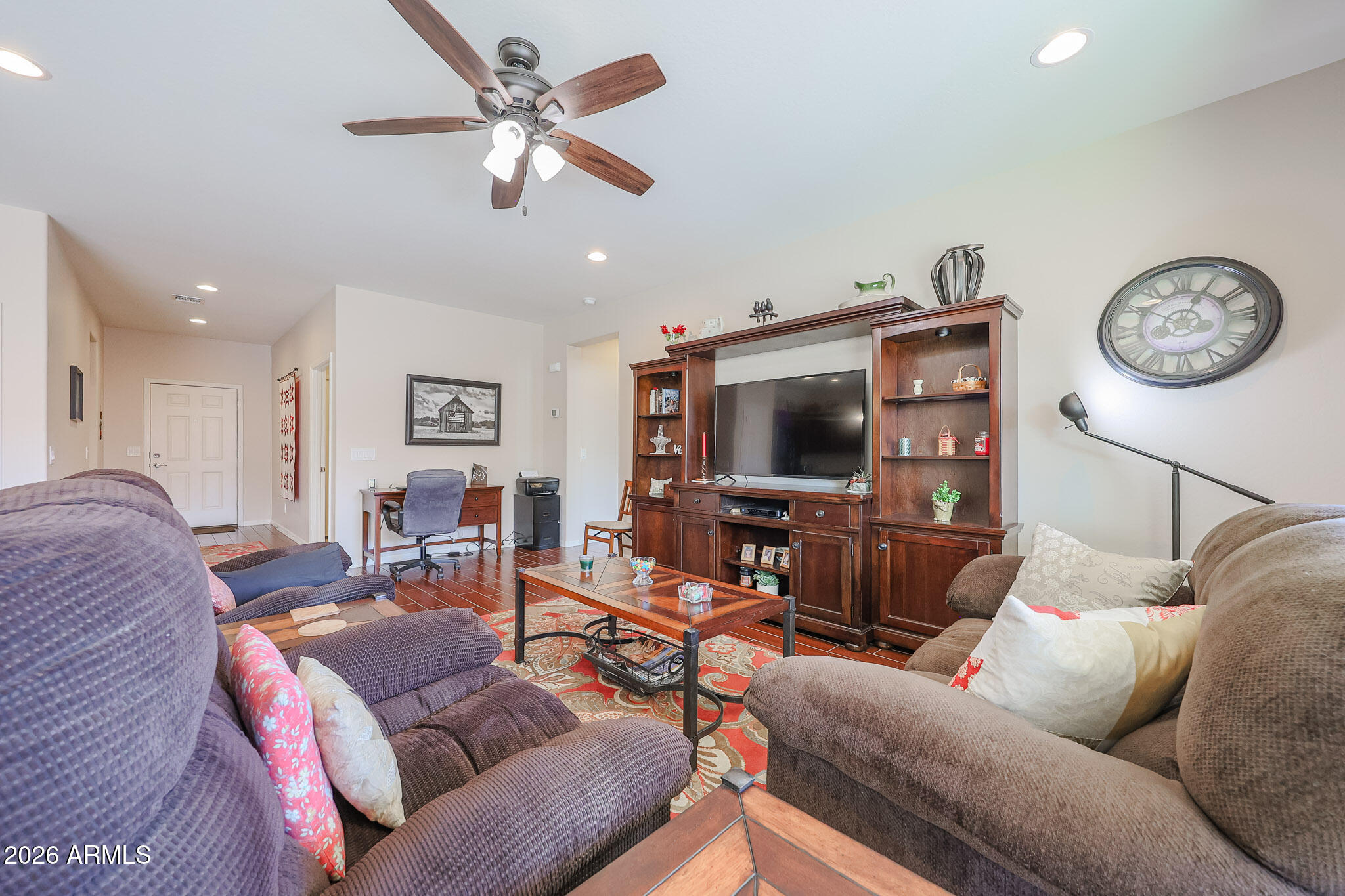 17545 West Fairview Street Goodyear, AZ 85338 - Photo 10 of 55 a living room with furniture a flat screen tv and a window