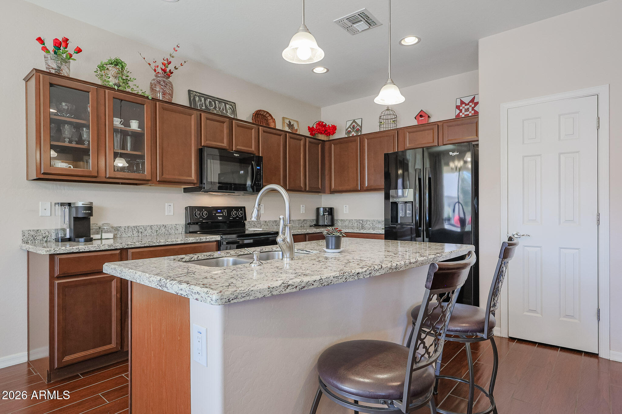 17545 West Fairview Street Goodyear, AZ 85338 - Photo 11 of 55 a kitchen with stainless steel appliances granite countertop a sink refrigerator and cabinets