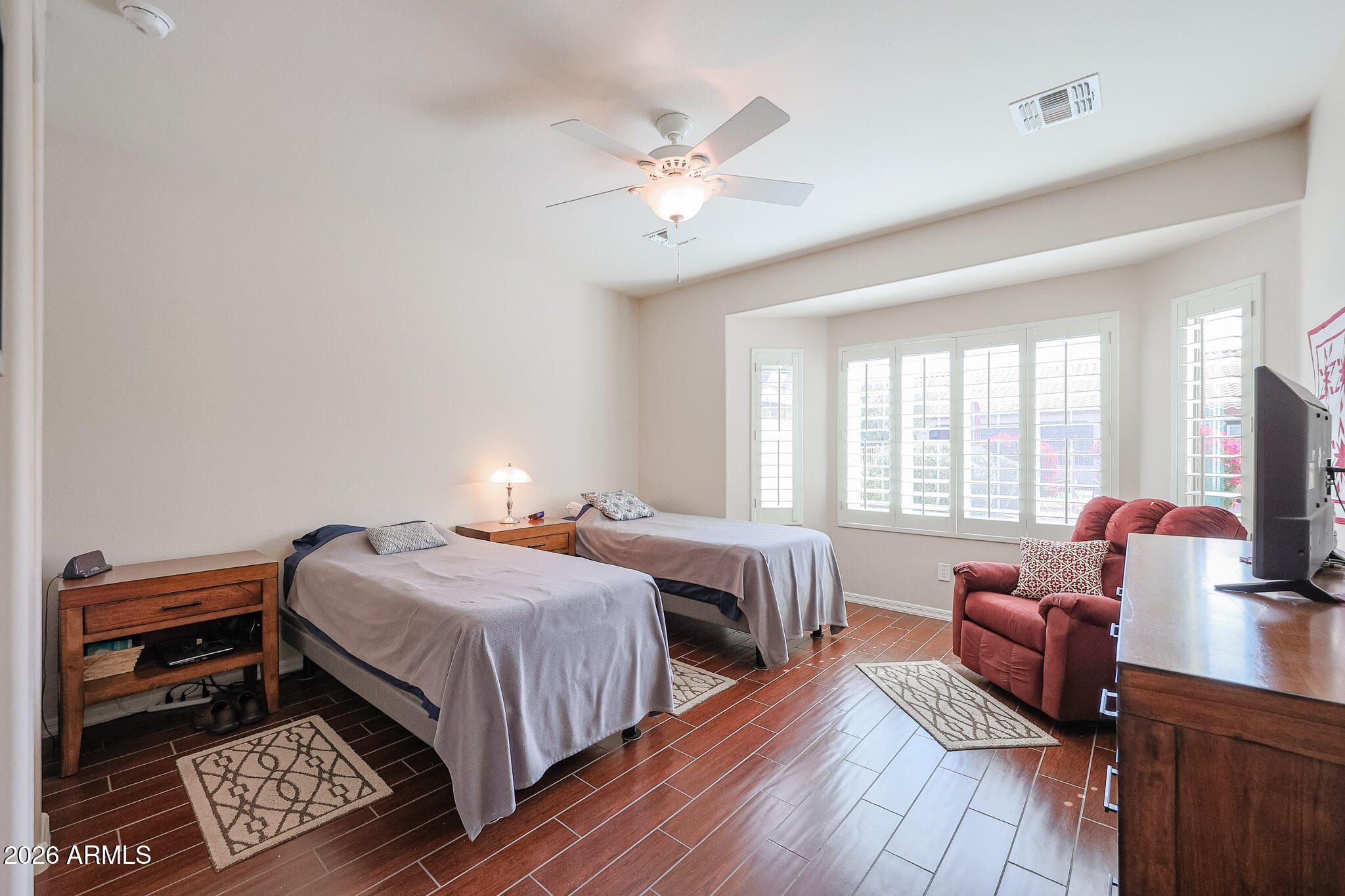 17545 West Fairview Street Goodyear, AZ 85338 - Photo 15 of 55 a bedroom with beds and a chandelier