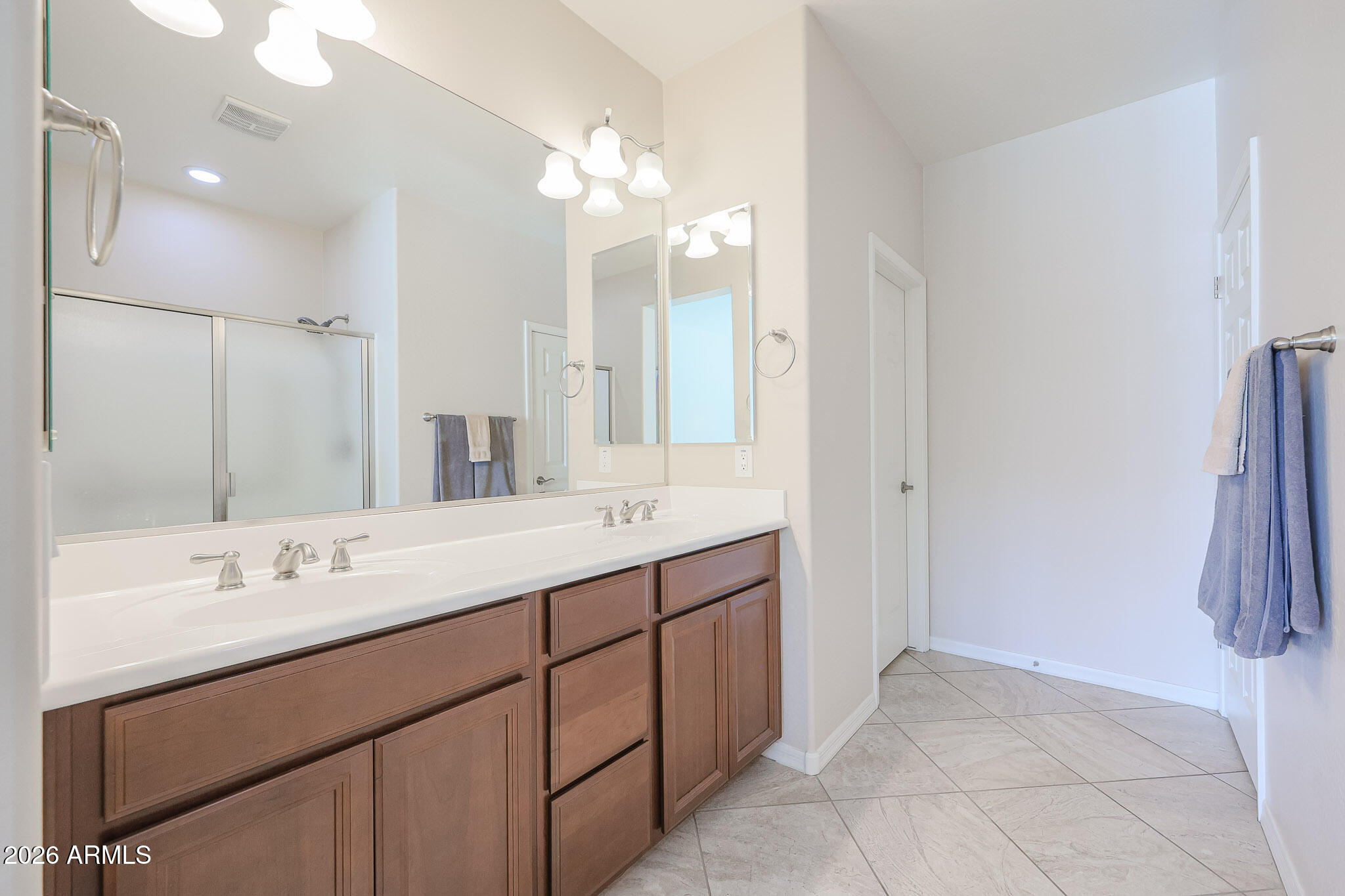 17545 West Fairview Street Goodyear, AZ 85338 - Photo 17 of 55 a bathroom with a double vanity sink and a mirror