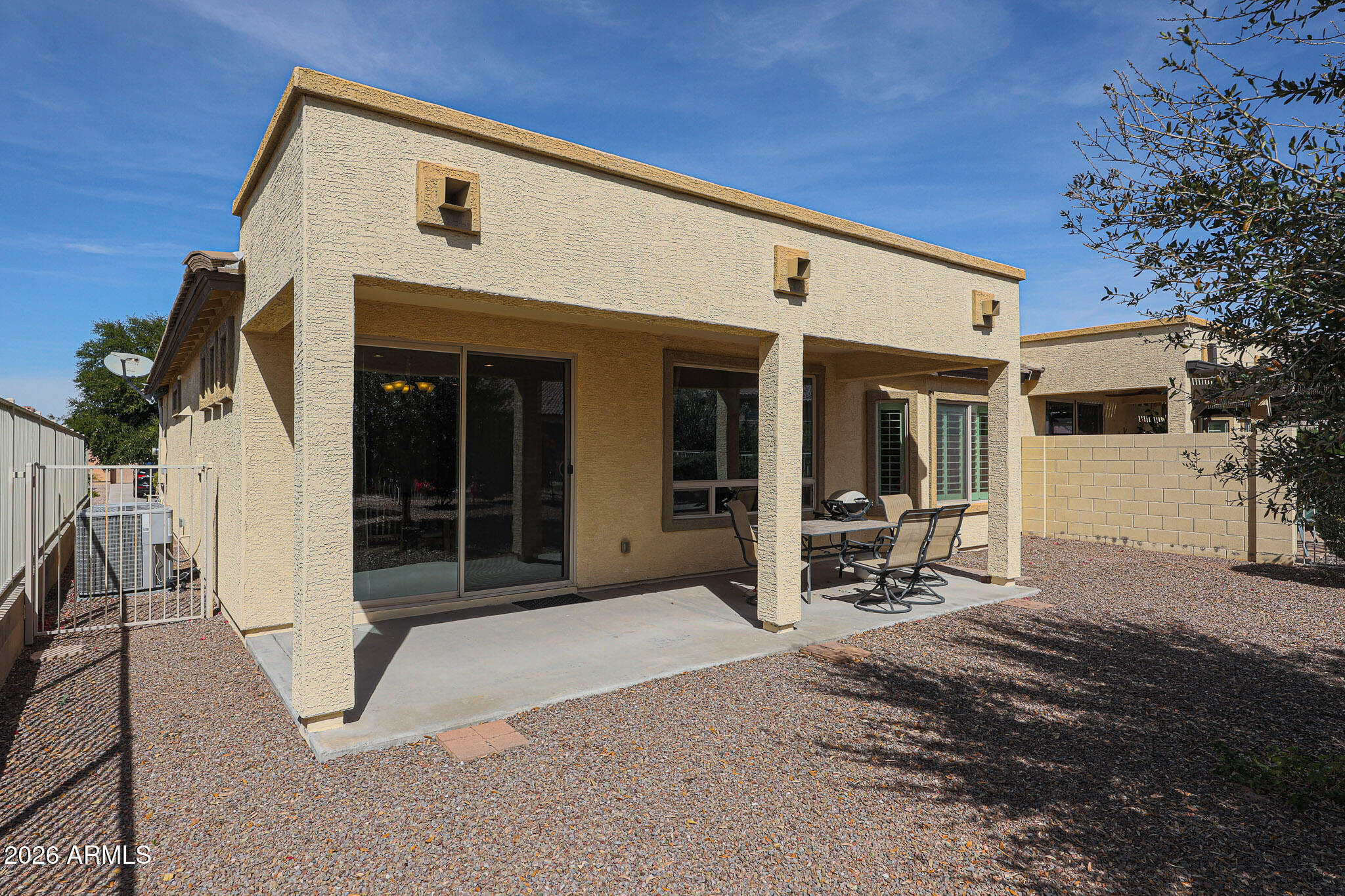 17545 West Fairview Street Goodyear, AZ 85338 - Photo 28 of 55 a front view of a house with glass windows and a yard