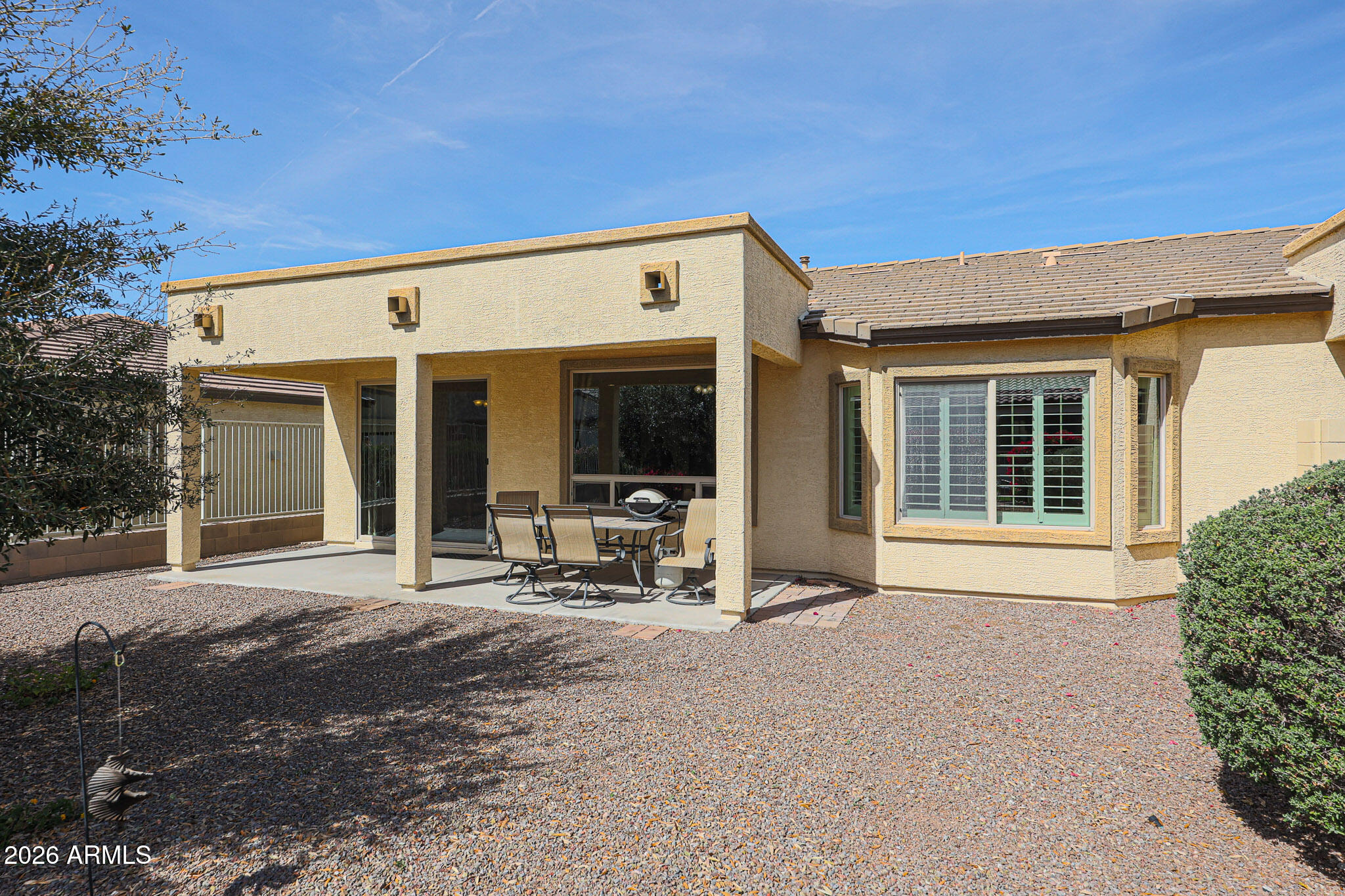17545 West Fairview Street Goodyear, AZ 85338 - Photo 29 of 55 a view of a house with patio area and garden