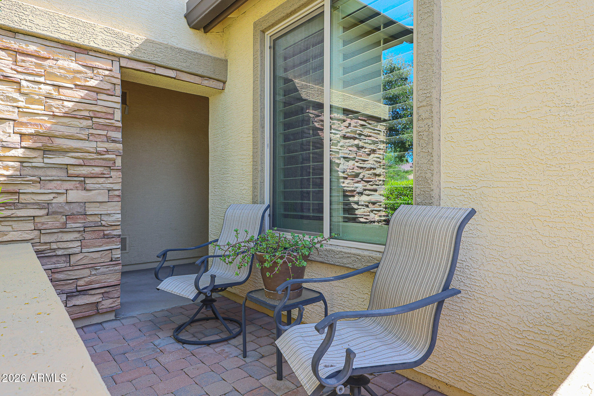 17545 West Fairview Street Goodyear, AZ 85338 - Photo 4 of 55 a view of a balcony with chair and a potted plant