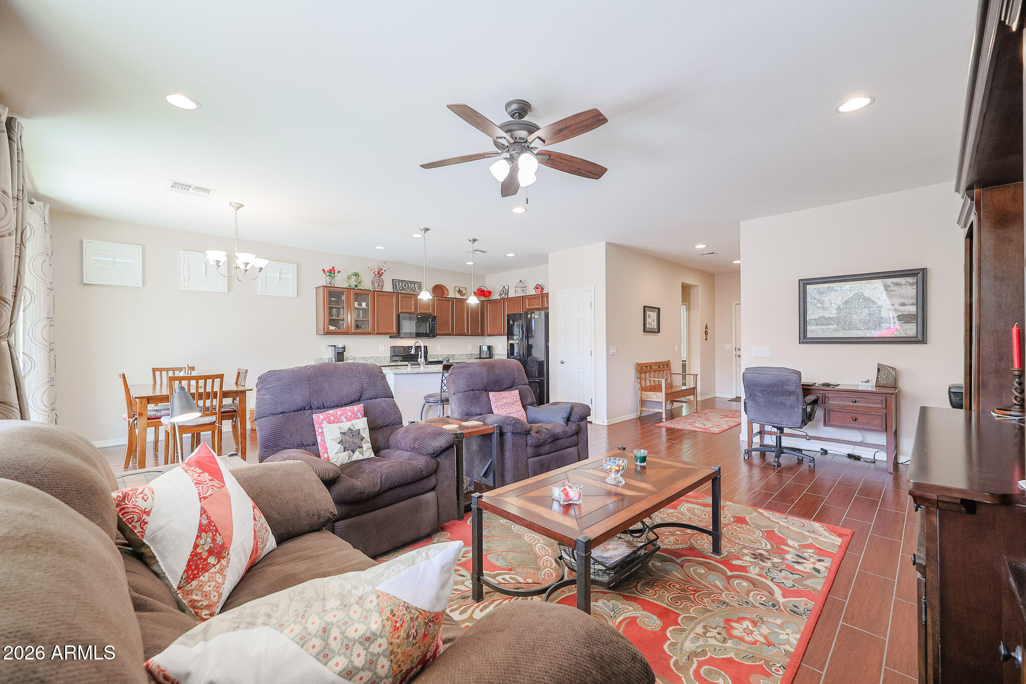 17545 West Fairview Street Goodyear, AZ 85338 - Photo 6 of 55 a living room with furniture a rug and a ceiling fan