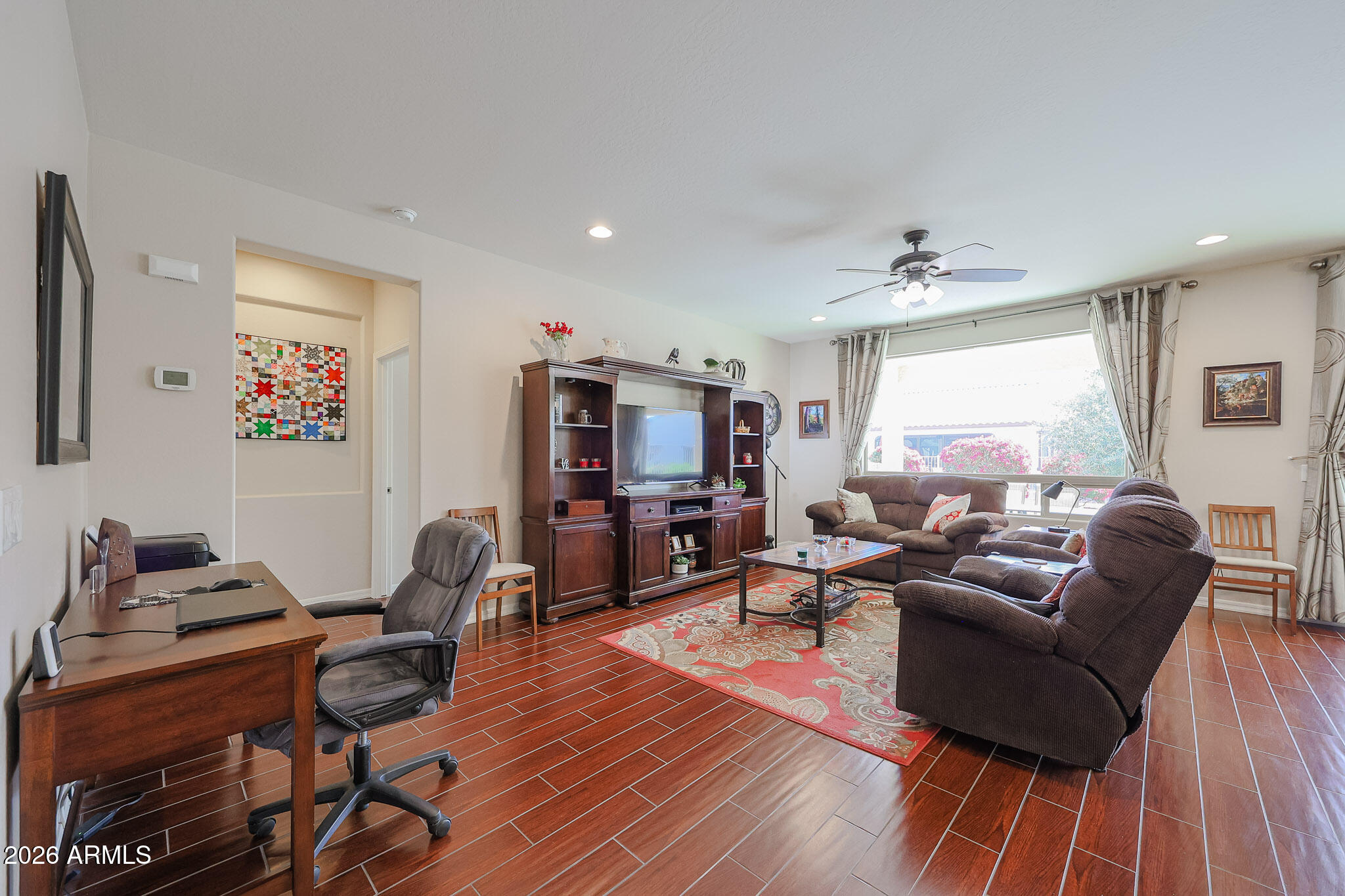 17545 West Fairview Street Goodyear, AZ 85338 - Photo 7 of 55 a living room with furniture and a flat screen tv