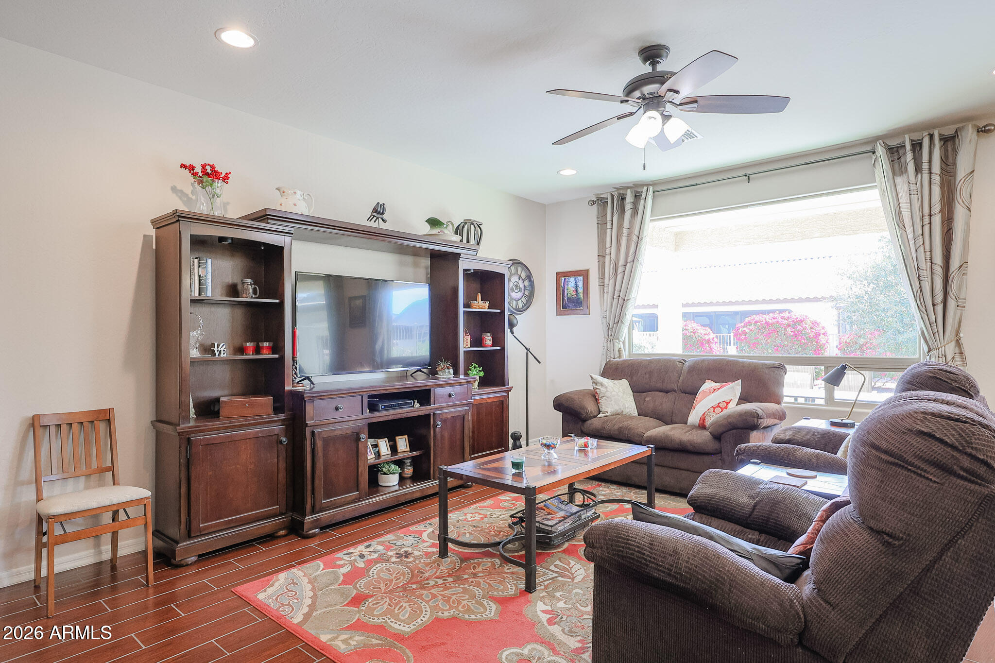 17545 West Fairview Street Goodyear, AZ 85338 - Photo 8 of 55 a living room with furniture and a flat screen tv