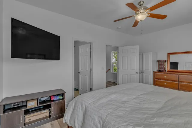 a bedroom with a bed and a flat screen tv