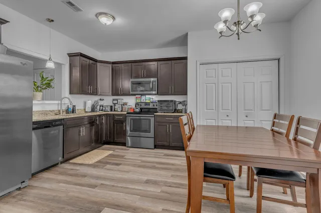 a kitchen with kitchen island a sink table and chairs