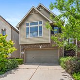a front view of a house with a yard and trees