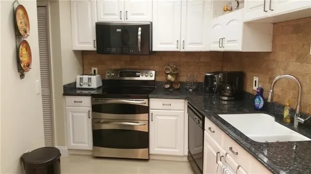 a kitchen with a sink and a stove top oven