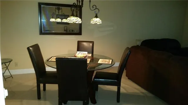 a dining room with furniture and chandelier