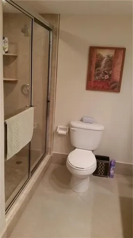 a white toilet sitting next to a bathroom sink