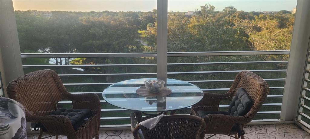 625 Oaks Drive, Unit 704 Pompano Beach, FL 33069 - Photo 7 of 10 a view of a chairs and table in the balcony
