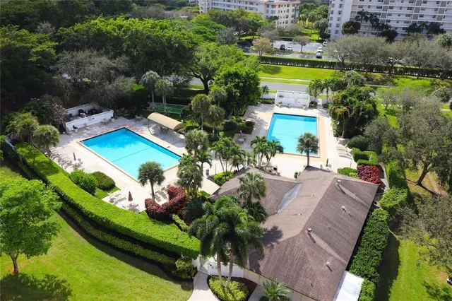 an aerial view of a house with a swimming pool yard and outdoor seating