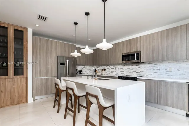 a kitchen with stainless steel appliances kitchen island a large island in the center