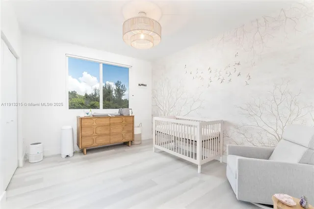 a spacious bedroom with a bed couch and window