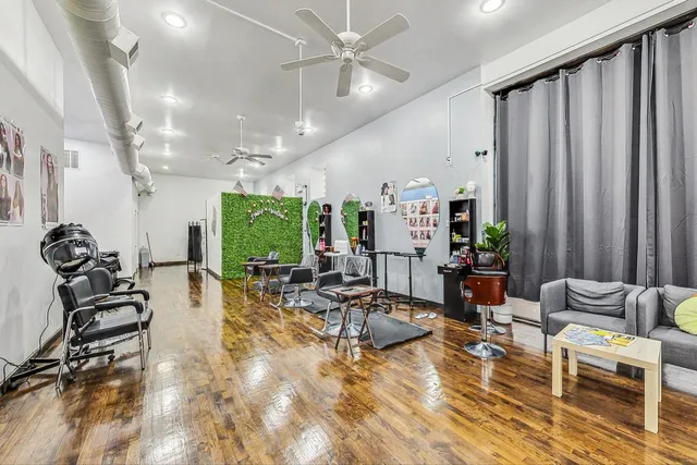 a room with lots of chairs and a large window