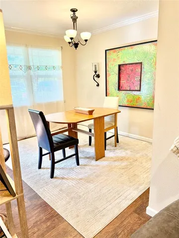 a view of a room with a table and chairs