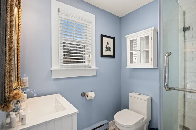 a white toilet sitting next to a bathroom sink