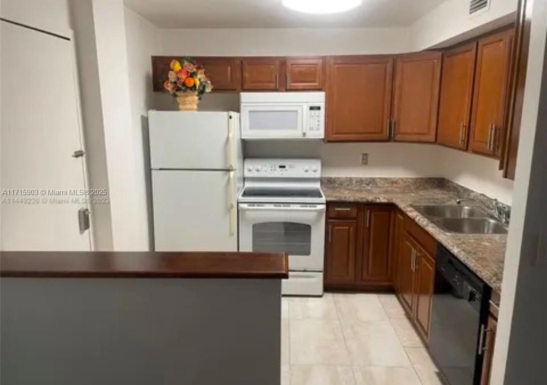 6700 Cypress Road, Unit 512 Plantation, FL 33317 - Photo 3 of 27 a kitchen with a refrigerator sink and cabinets
