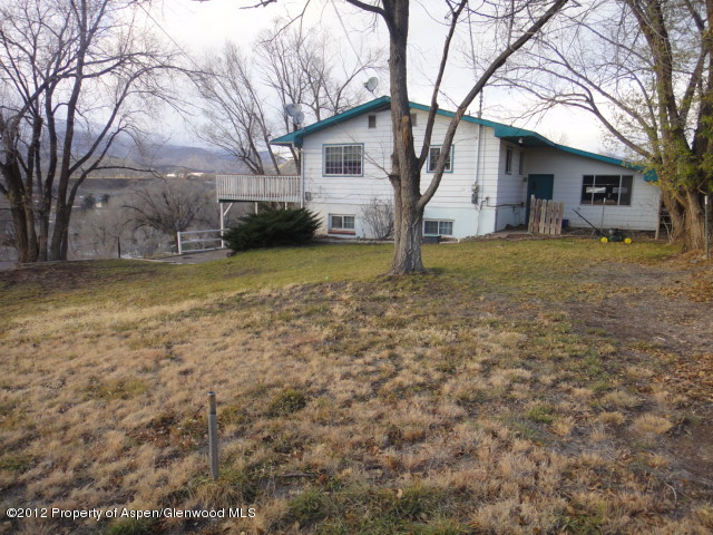 409 East 4th Street Rifle, CO 81650 - Photo 1 of 19 a view of a house with a yard