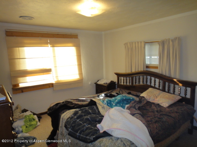 409 East 4th Street Rifle, CO 81650 - Photo 13 of 19 a bedroom with bed and a window