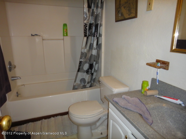 409 East 4th Street Rifle, CO 81650 - Photo 14 of 19 a bathroom with a sink a toilet and shower
