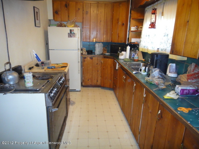409 East 4th Street Rifle, CO 81650 - Photo 15 of 19 a kitchen with a sink stove and refrigerator