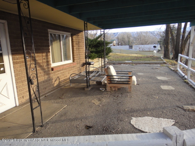 409 East 4th Street Rifle, CO 81650 - Photo 17 of 19 a view of a patio with table and chairs and wooden fence