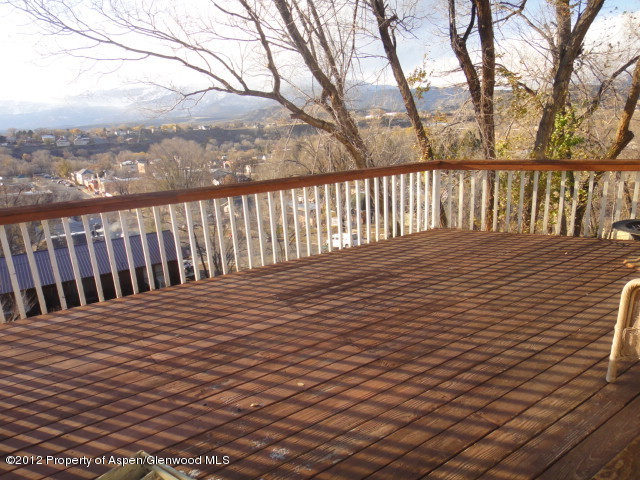 409 East 4th Street Rifle, CO 81650 - Photo 2 of 19 a balcony with wooden floor and fence