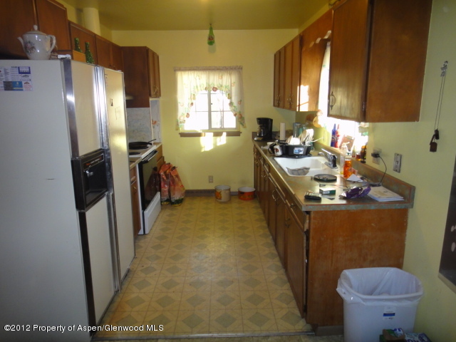 409 East 4th Street Rifle, CO 81650 - Photo 5 of 19 a kitchen with a sink stove and refrigerator