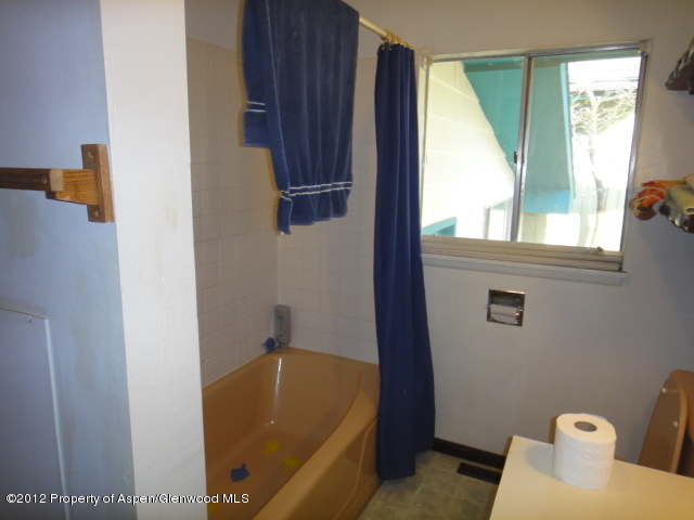 409 East 4th Street Rifle, CO 81650 - Photo 7 of 19 a bathroom with a tub and sink