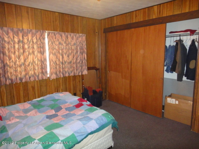 409 East 4th Street Rifle, CO 81650 - Photo 10 of 19 a bedroom with a bed and a mirror