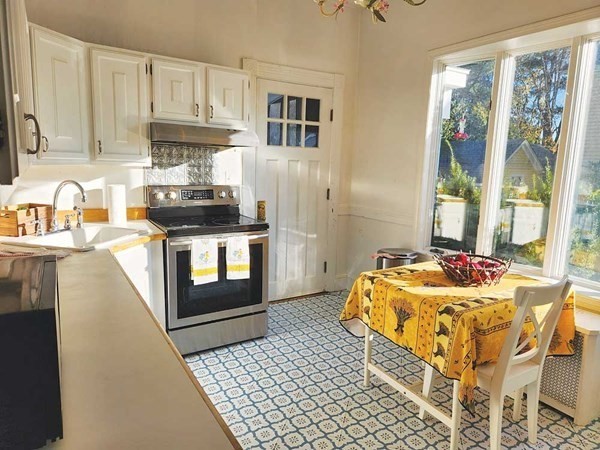 60 Maple Street Framingham, MA 01702 - Photo 13 of 24 a kitchen with a stove a sink and a refrigerator