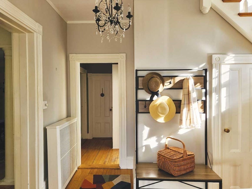 60 Maple Street Framingham, MA 01702 - Photo 5 of 24 a hallway with dining room and chandelier